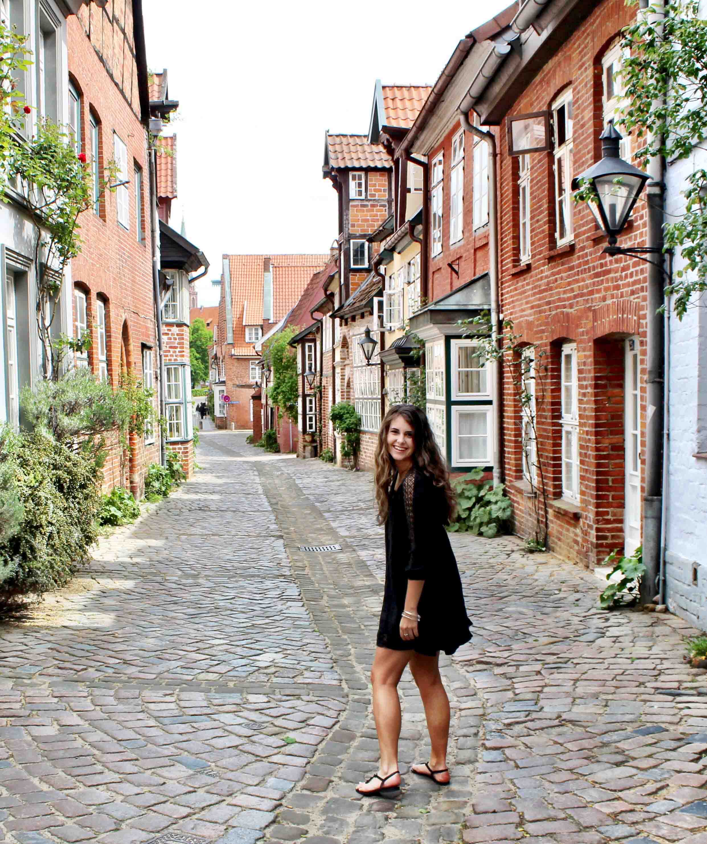 Student walking the historic streets in Lüneburg, Germany.