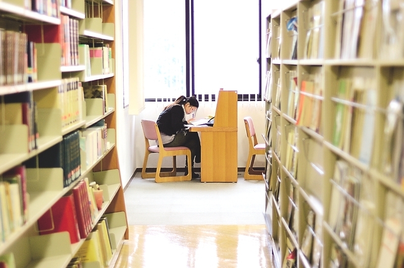 A student studying in the library of Nagasaki University in Japan.