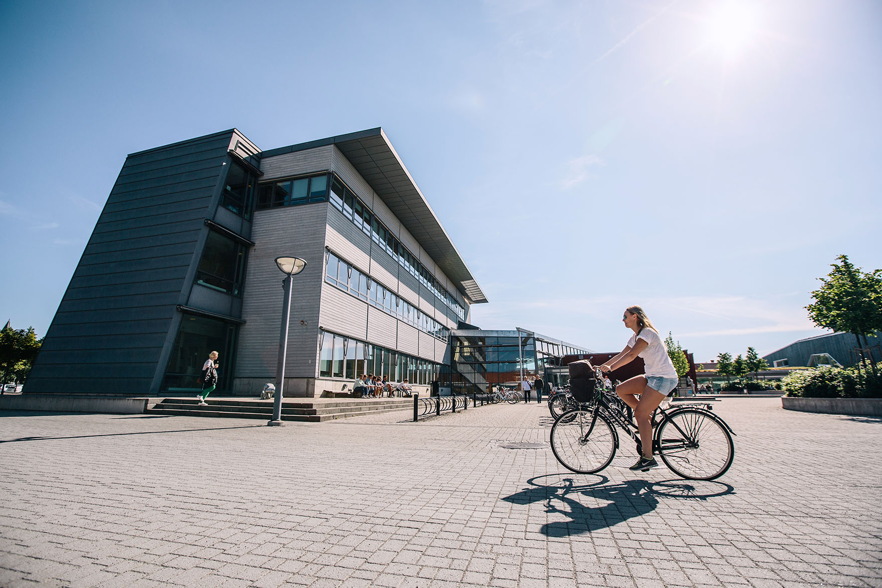 Student riding their bike on campus at Linnaeus University in Växjö, Sweden.