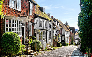 Classic English homes along a cobblestone street in East Sussex, England.