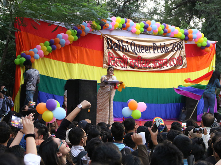 A person speaking on stage at the Delhi Queer Pride festival in India.