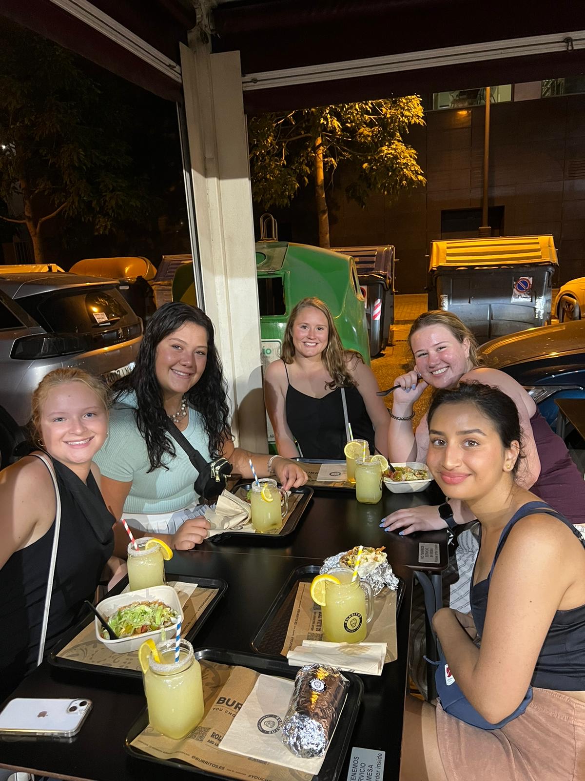 A group of University of Maine students enjoying dinner at a table while studying abroad in Valencia, Spain.