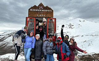 Students standing atop the Andes mountains in Chile.