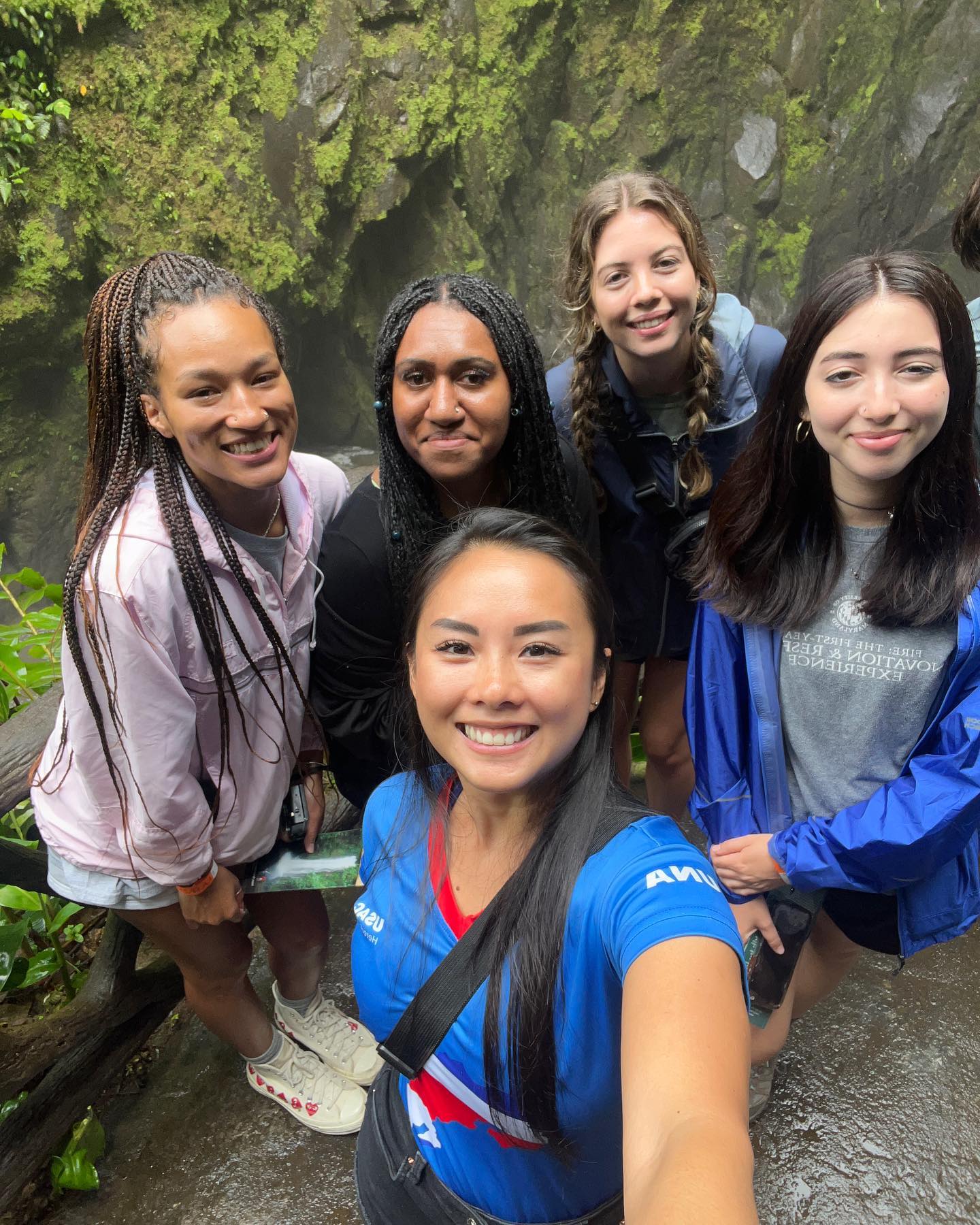 Five people on a hike with the rain forest in the background in Costa Rica.