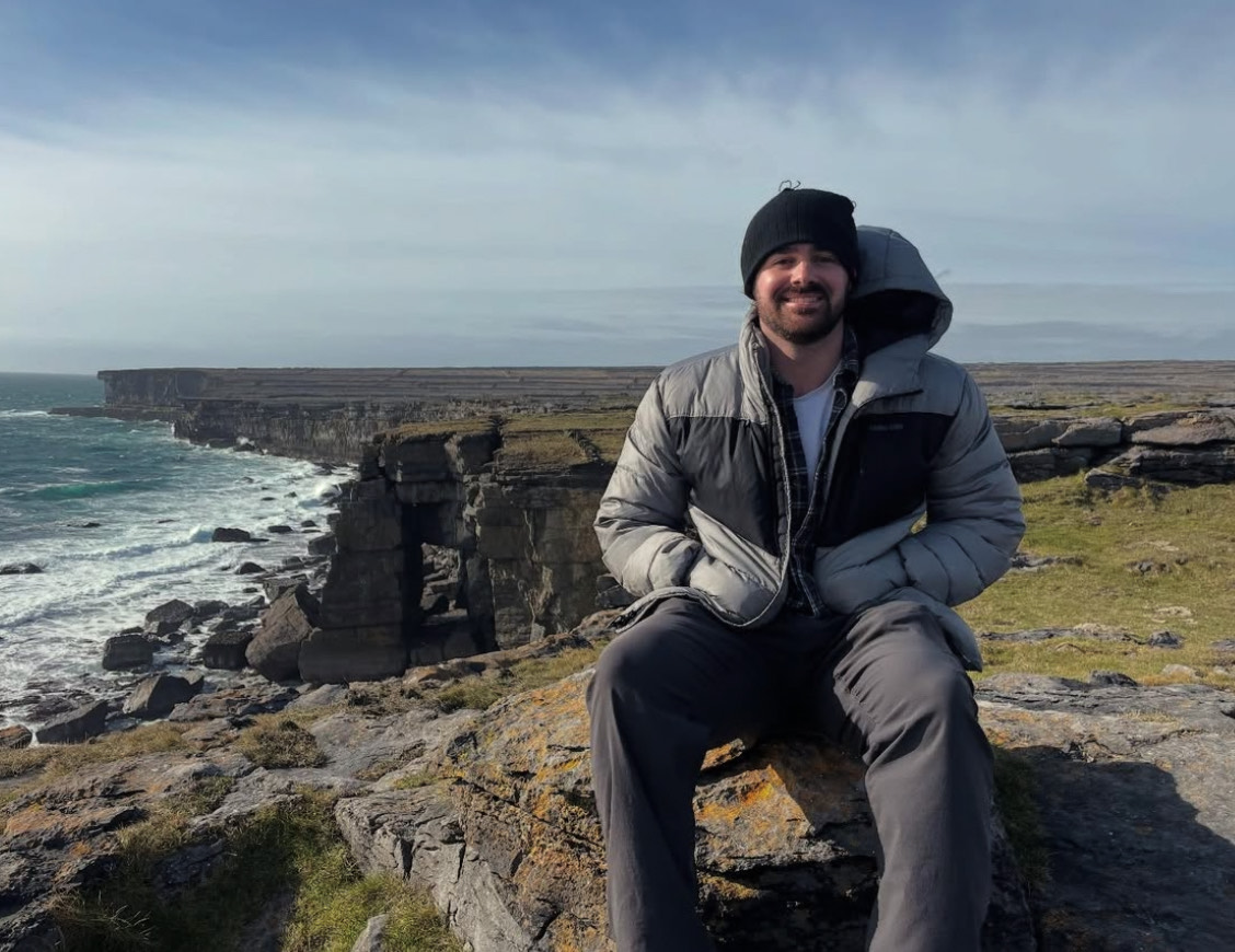 Griffin sitting on a rock overlooking the ocean on the Aran Islands in Ireland.