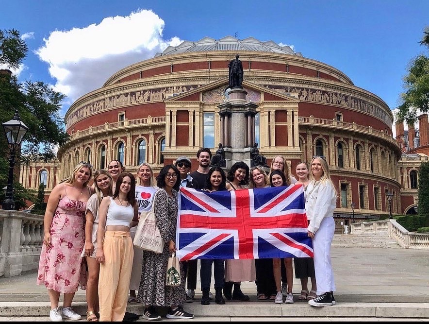 Griffin with a group of students holding the British flag in London, England.