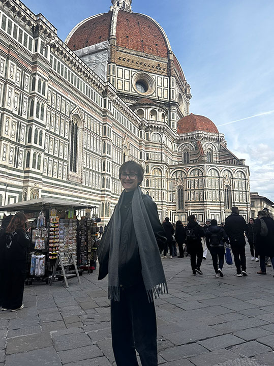 Trey Kirkpatrick in front of historic buildings while studying abroad in Viterbo, Italy.