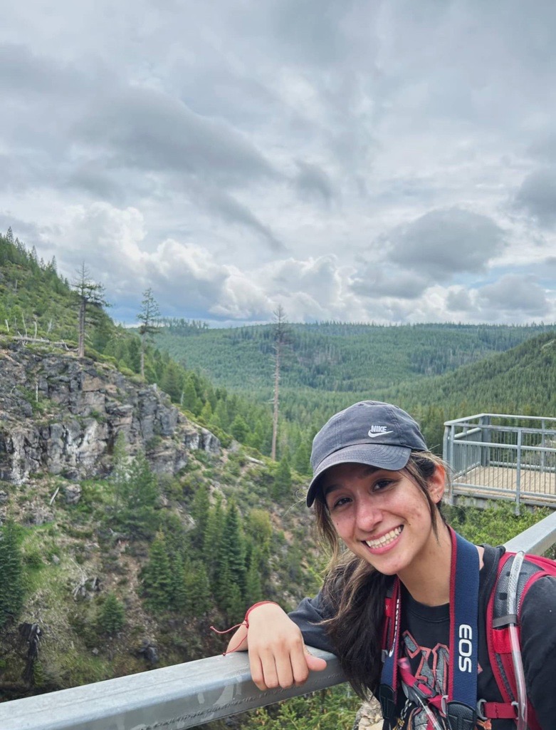 Ariana at the top of a mountain overlook.