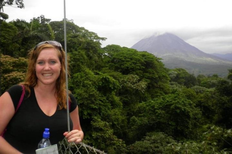 Bonnie posing on a bridge overlooking the rainforest and Arenal in Costa Rica.