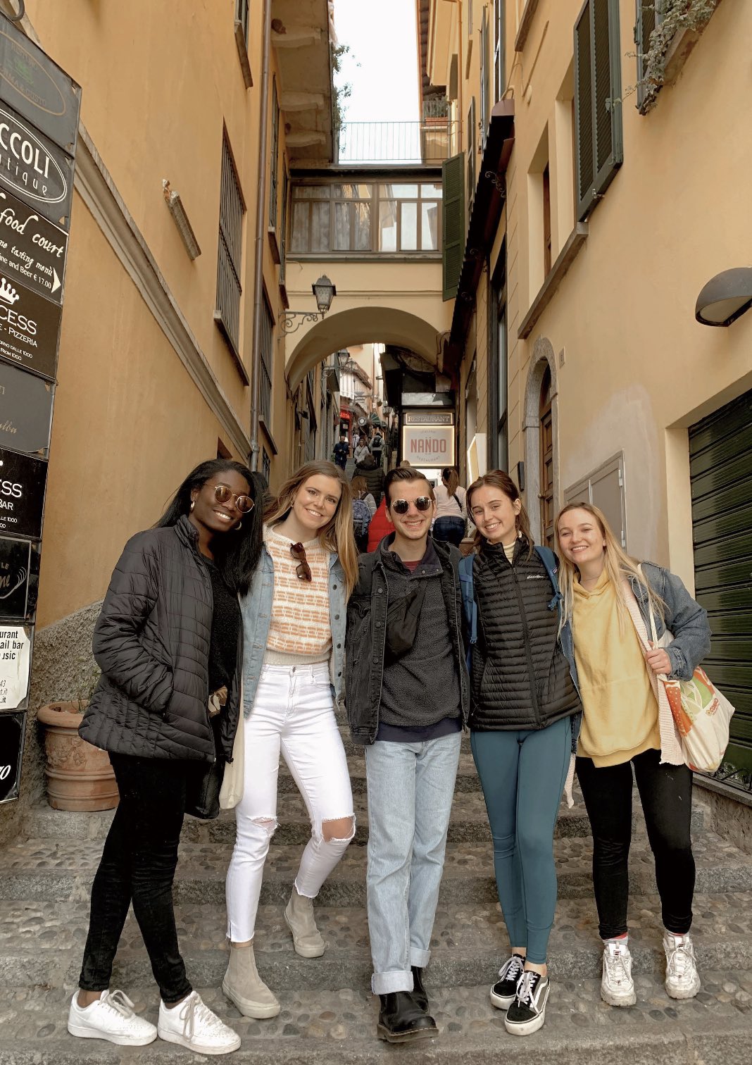 Danny with a group of friends posing in the streets of Italy.