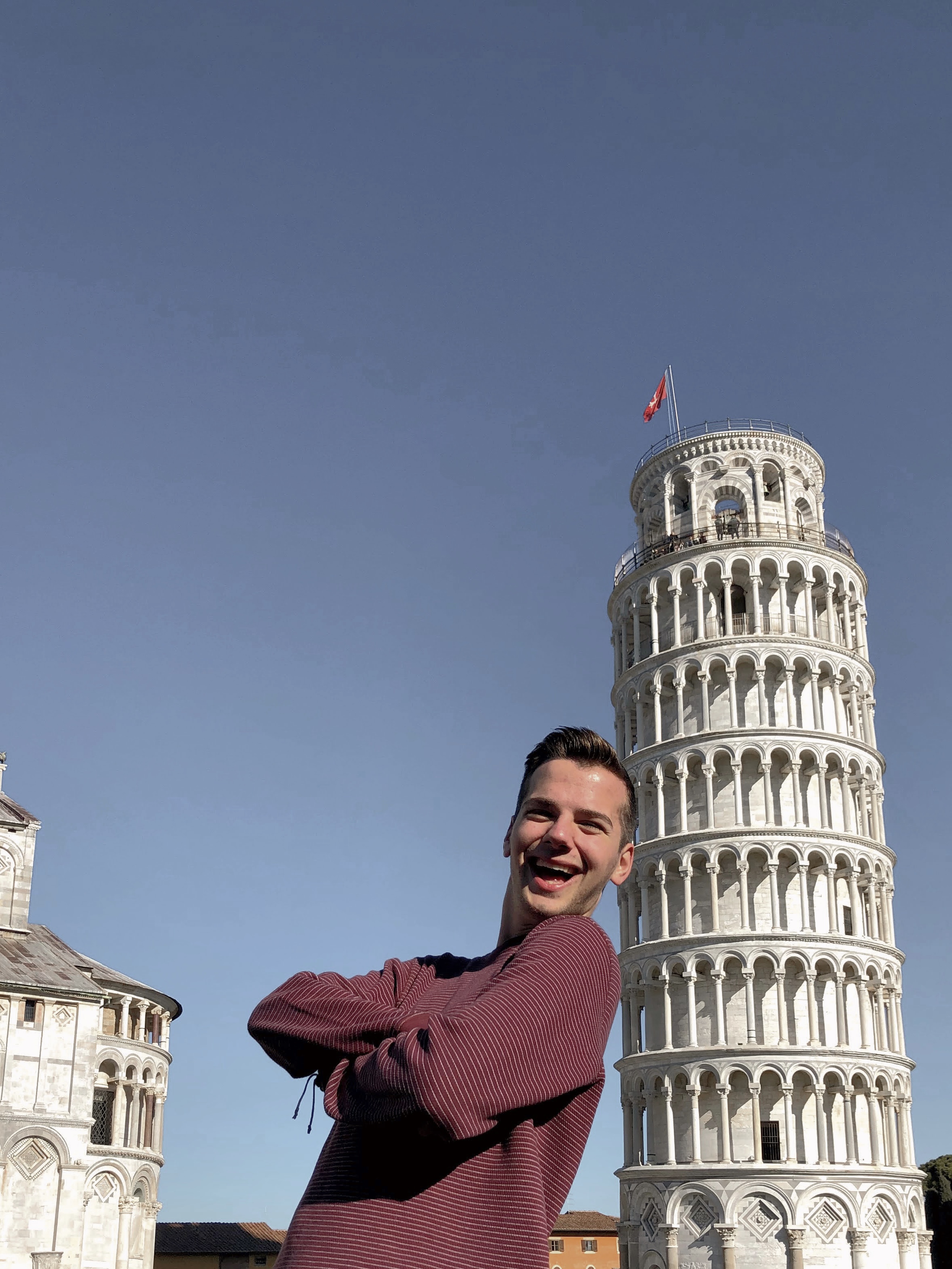 Danny taking the iconic photo next to the Leaning Tower of Pisa.