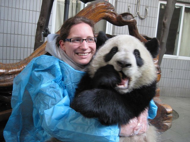 Dominique hugging a panda bear.