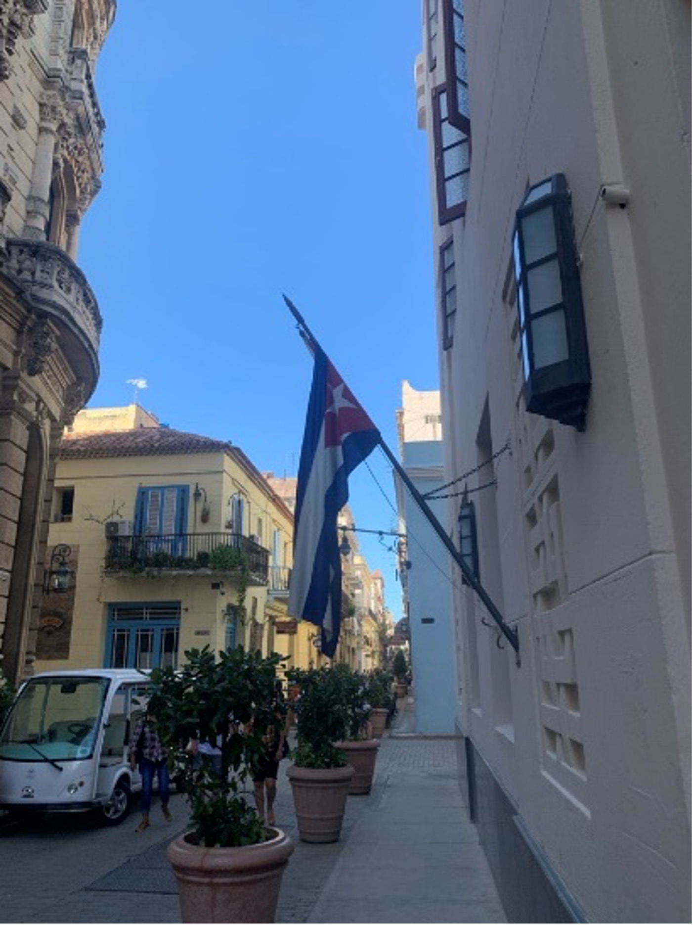 A view of historic buildings and the Cuban flag in La Habana, Cuba.