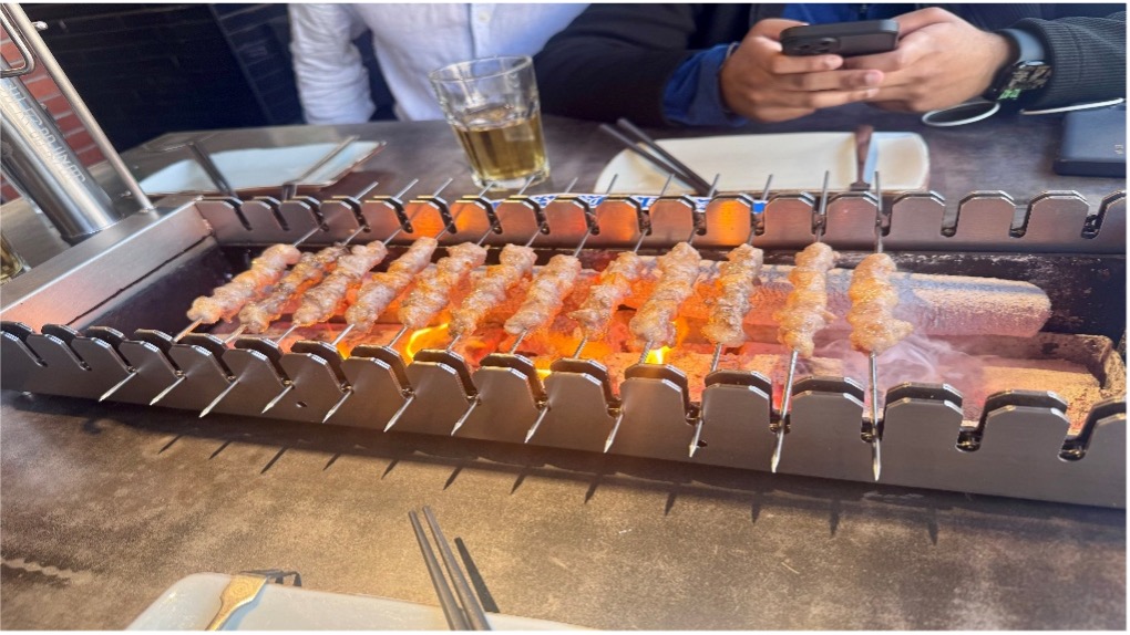 Skewers of peking duck on a grill in China.