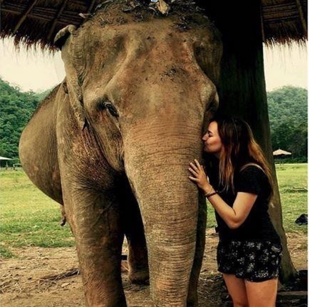 Kat Rogers kissing an elephant at the Elephant Nature Park in Chiang Mai, Thailand.