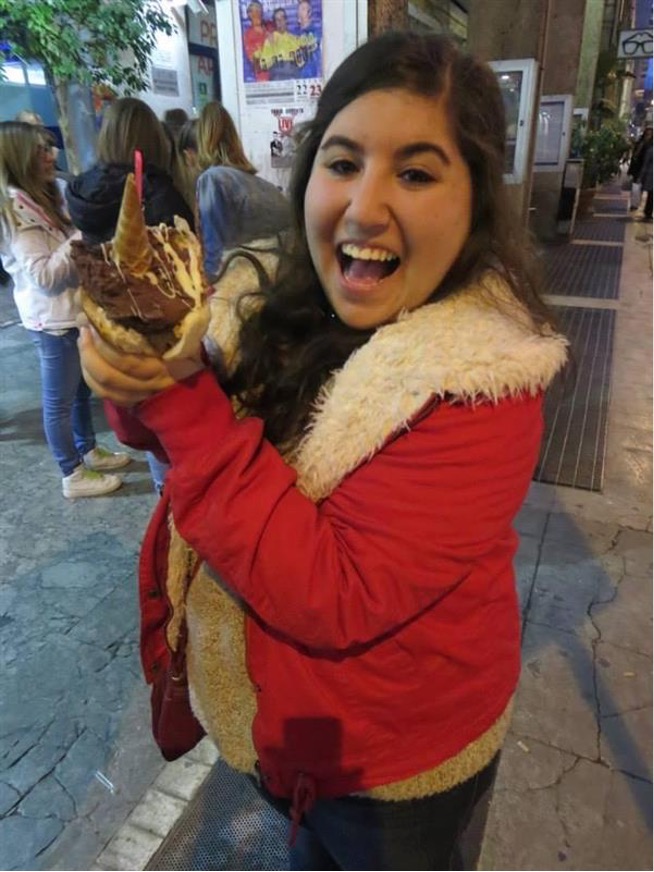 Rachel Alperstein eating gelato in a brioche bun.