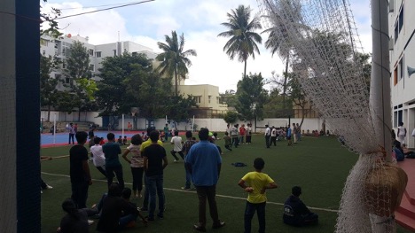 A group of people playing soccer in Bengaluru, India.