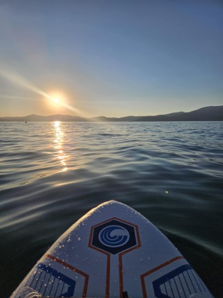 View of a paddleboard on Lake Tahoe at sunset.