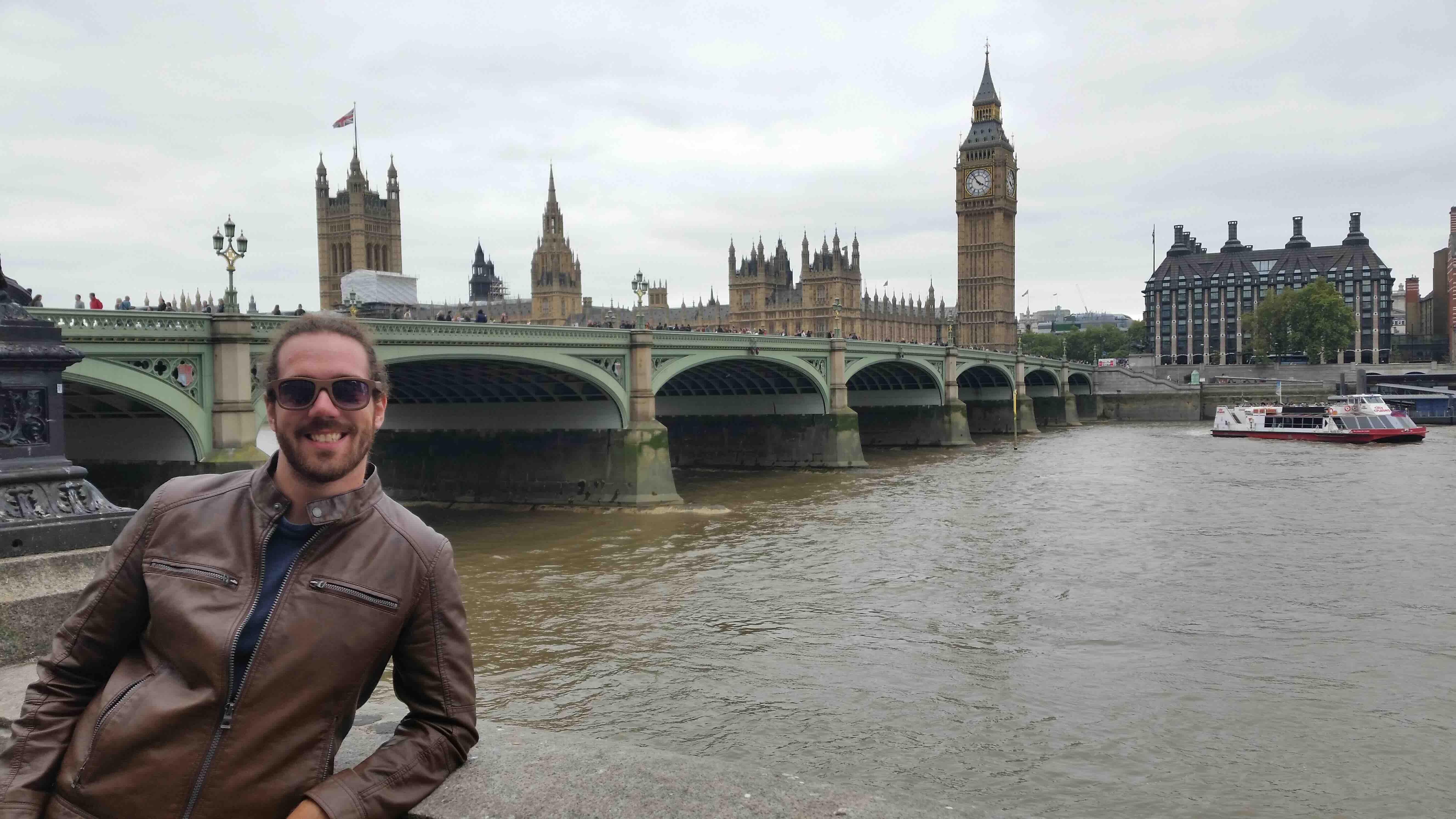 Charles standing by the River Thames in London, England with Big Ben and Parliament in the background. 