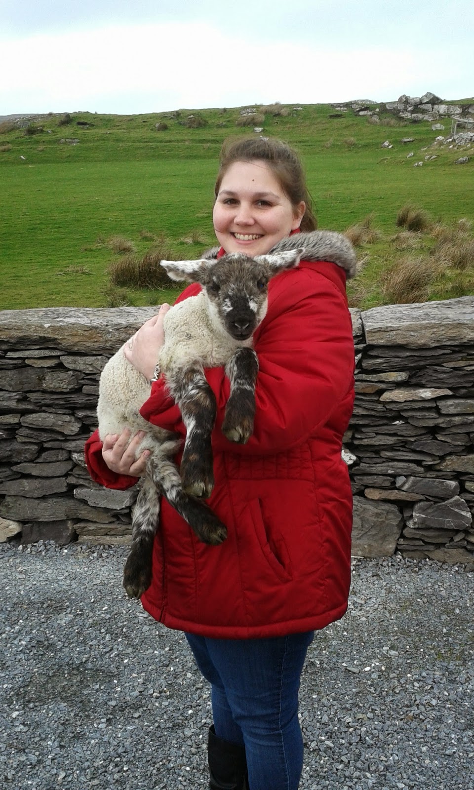 Emily holding a lamb in Cork, Ireland.