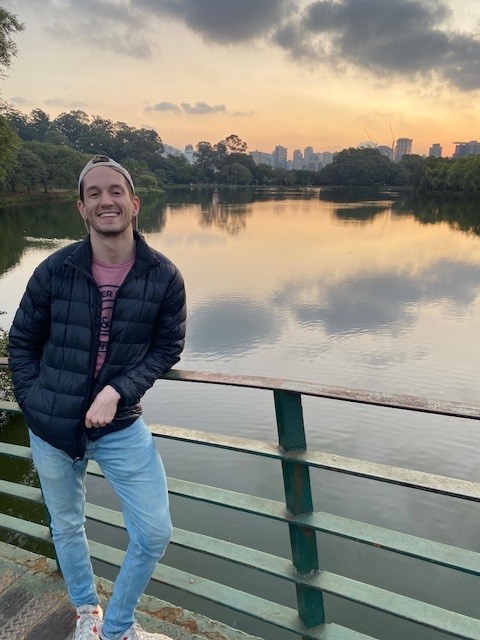 Jonathan standing on a bridge with the city skyline of Sao Paulo, Brazil in the background.