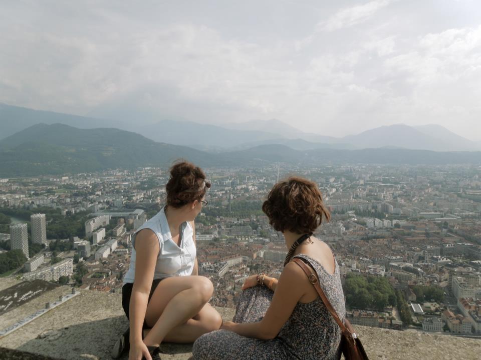 Kelsey sitting with a friend overlooking Grenoble, France.