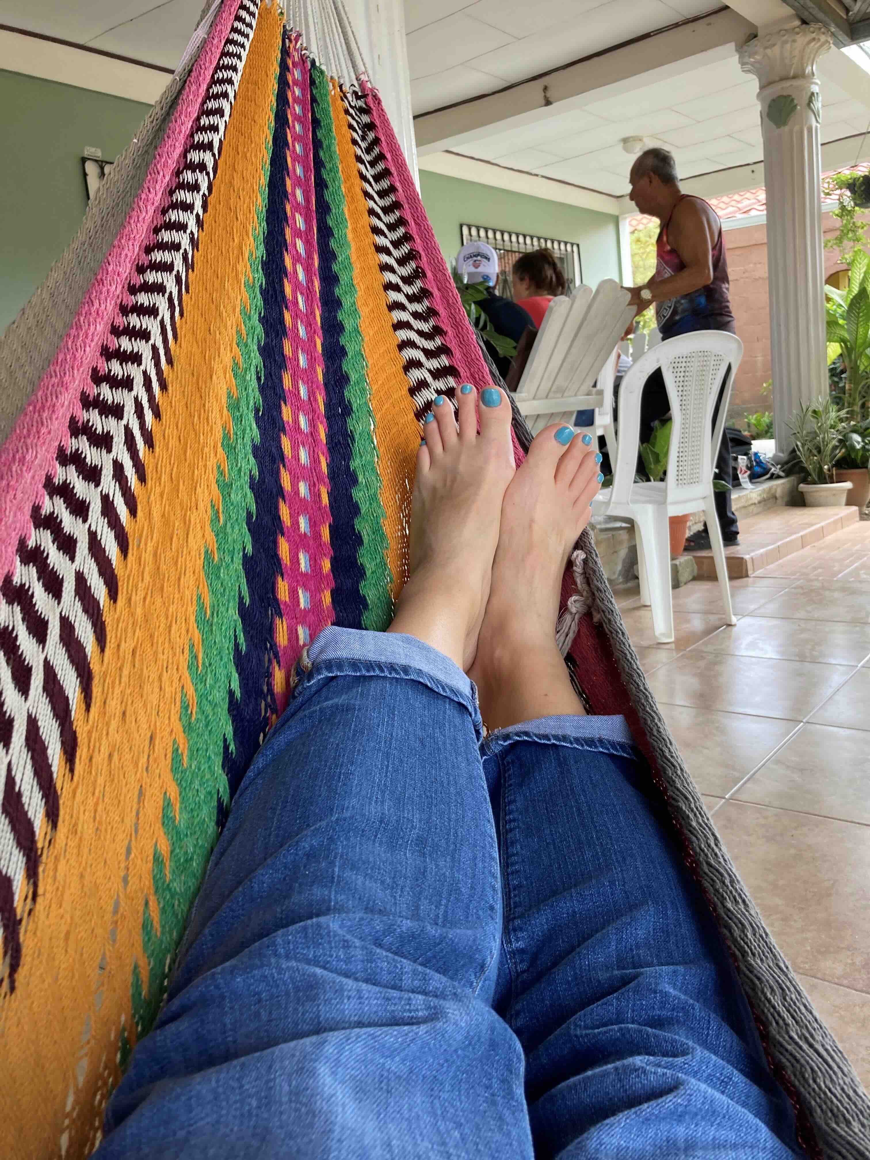 Kim relaxing on a colorful hammock in La Lima, Honduras.