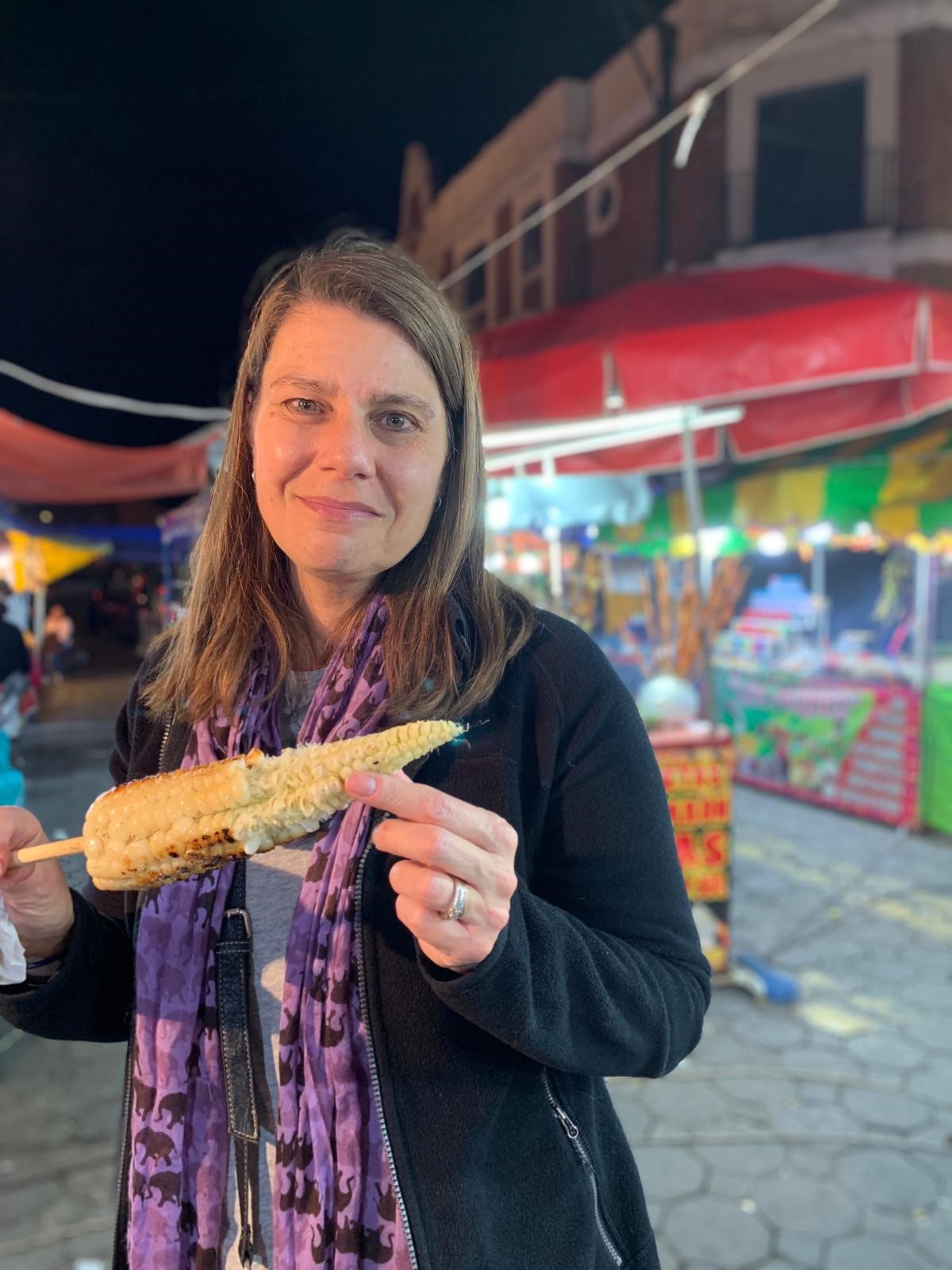 Kim enjoying street corn at a night market in Puebla, Mexico.