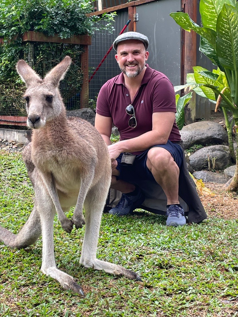 Thomas posing with a kangaroo in Australia.