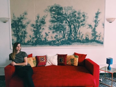 Rachel sitting on a couch in her apartment in Viterbo, Italy.