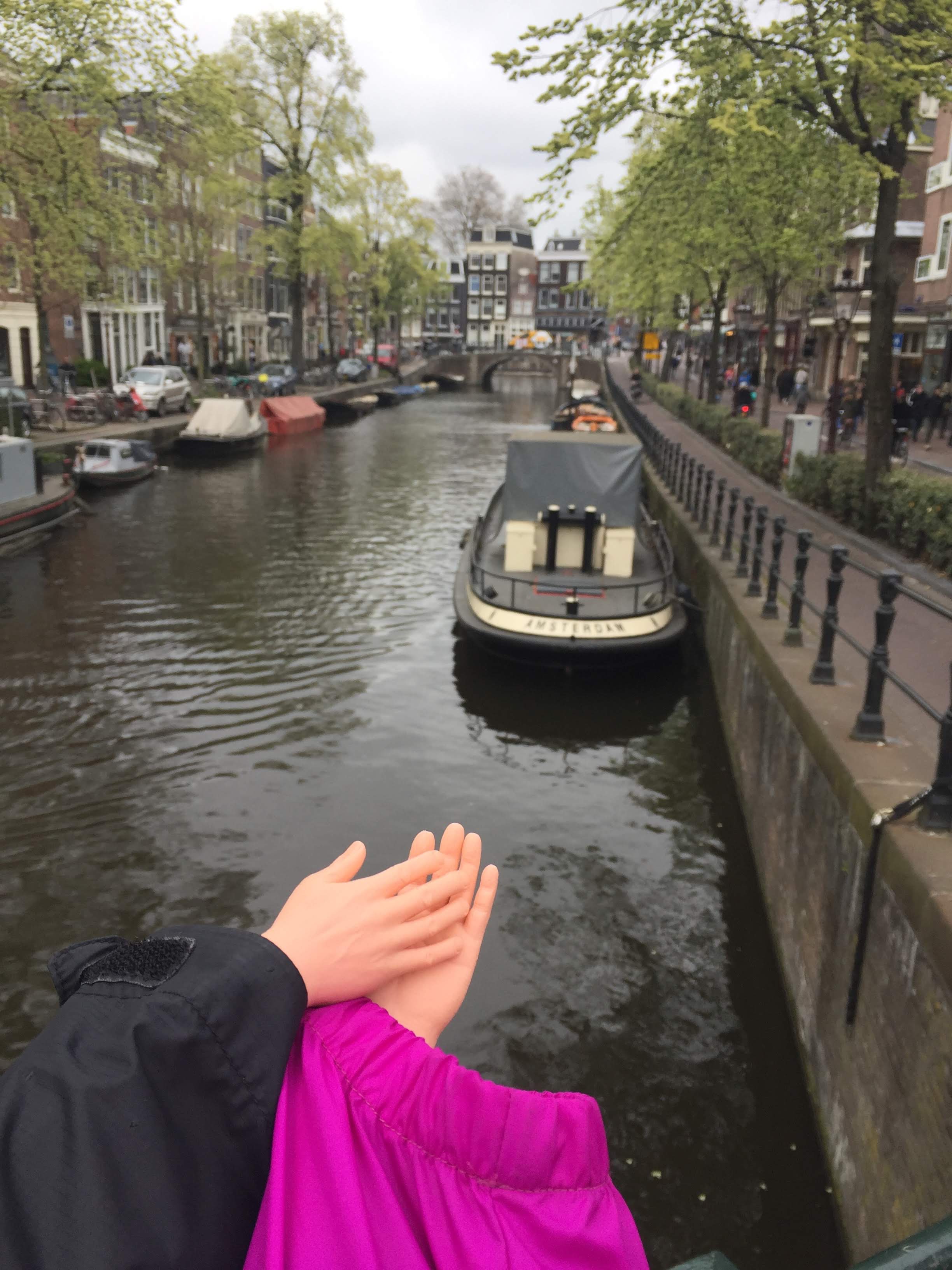 Holding hands over the canals of Amsterdam.