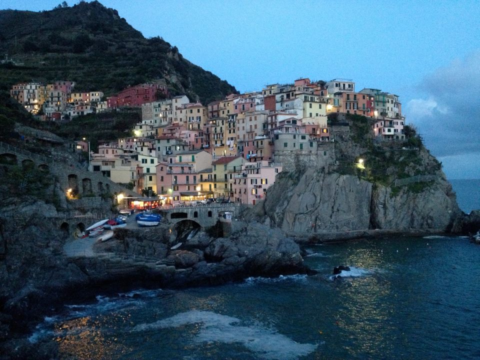 A view of Cinque Terre and Lake Como, Italy at night.