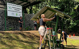 USAC student helping clean in Heredia, Costa Rica on World Volunteer Day