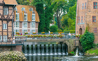 View of historic buildings lining a river in Germany.