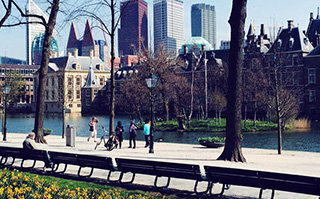 View of historic buildings and a river in the Netherlands.