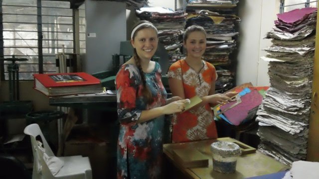 Two students making recycled paper in India.