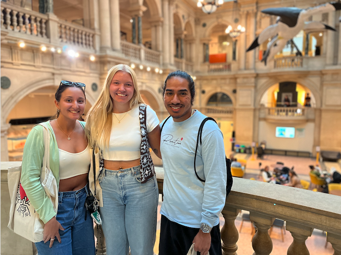 Three students standing in the Bristol Museum in Bristol, England.