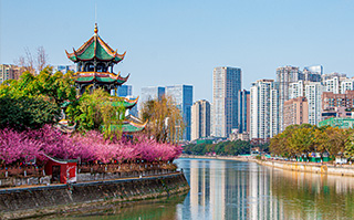 View of traditional and modern buildings on either side of the river in Chengdu, China.