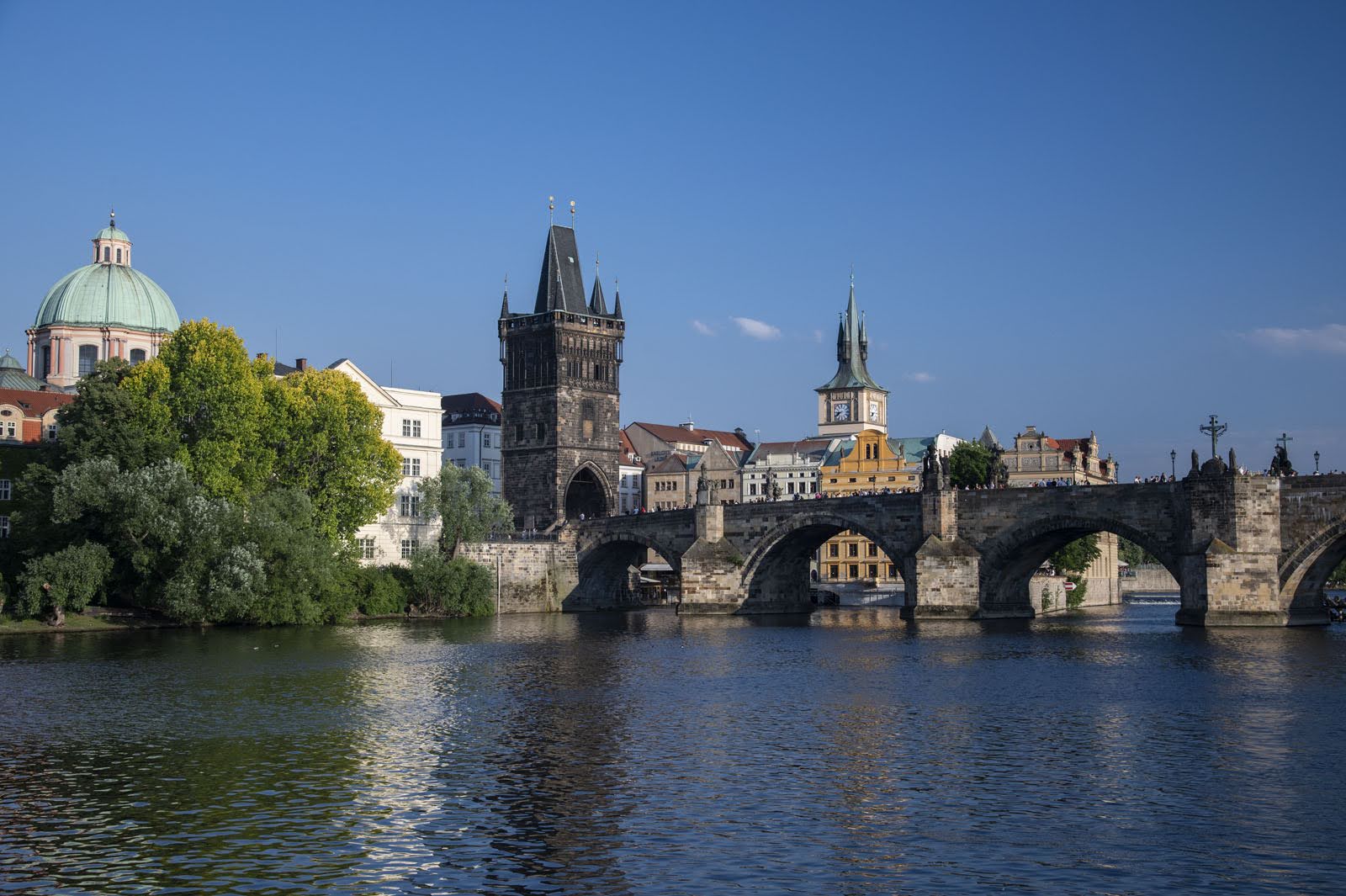 View of historic buildings and bridge over the river in Prague, Czech Republic.