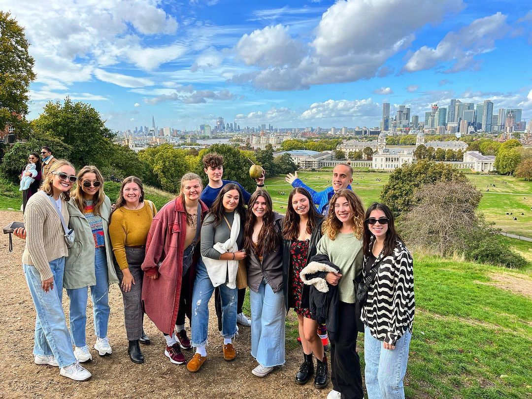 Group of students with the Greenwich skyline in the background.