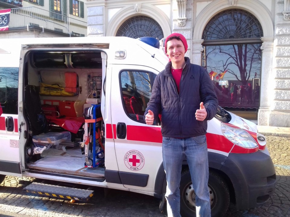 Student standing in front of a medical van.