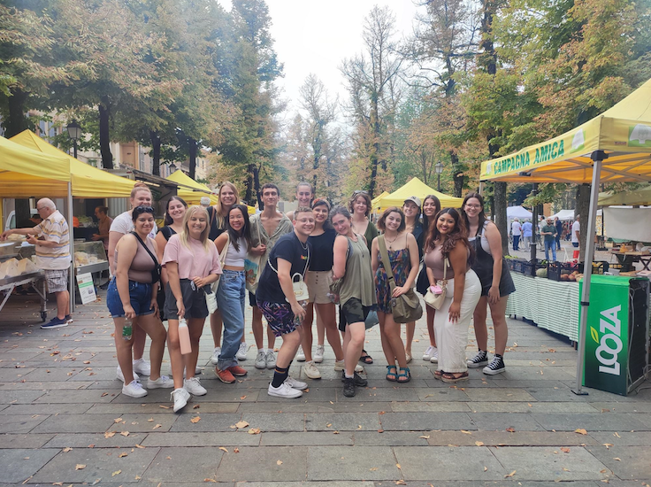 Students posing together while at a market in Reggio Emilia, Italy.