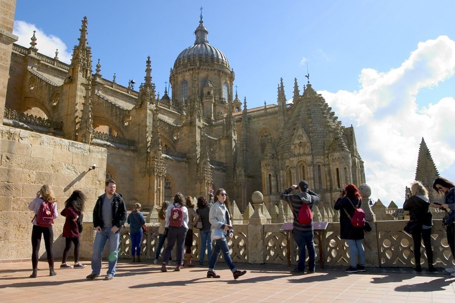 Students walking around admiring the Salamanca Cathedral in Spain.