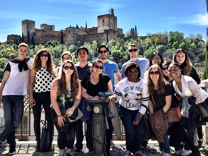 A group of students posing in front of La Alhambra in Granada.