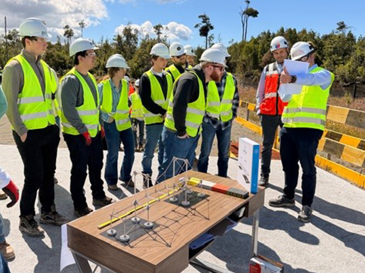 Students in yellow construction vests attending a faculty-led session abroad.