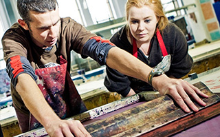 Two students making screen print are in Wellington, New Zealand.