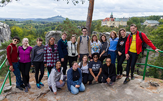 A group of students overlooking a mountain with a castle in Prague, Czech Republic.