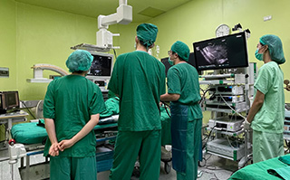 A group of students in scrubs in an operating room during their health internship in Khon Kaen, Thailand.