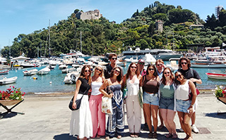 Students in front of a lake in Italy.