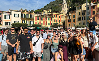 A group of students in a historic square in Torino, Italy.